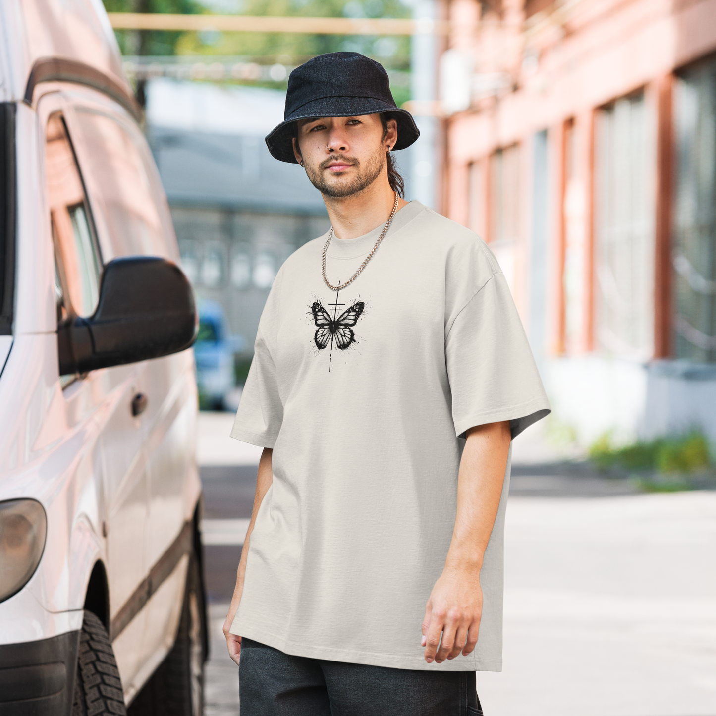 Oversized faded t-shirt with butterfly and cross in a minimalist artistic style